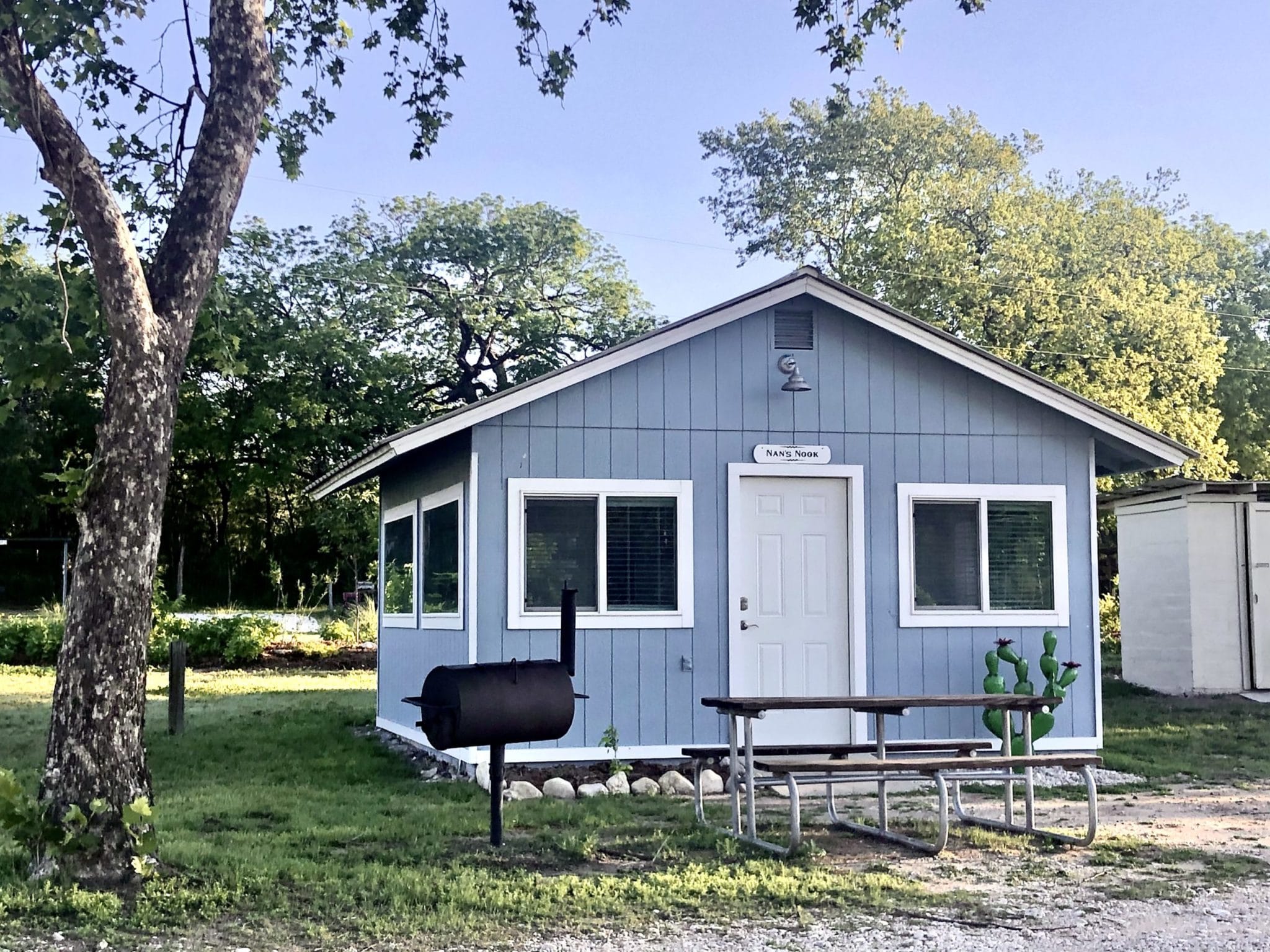 One-bedroom cabin with a picnic table and grill at Camp Riverview