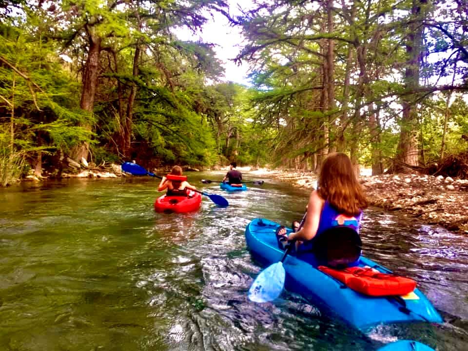 Family kayaking the Frio River