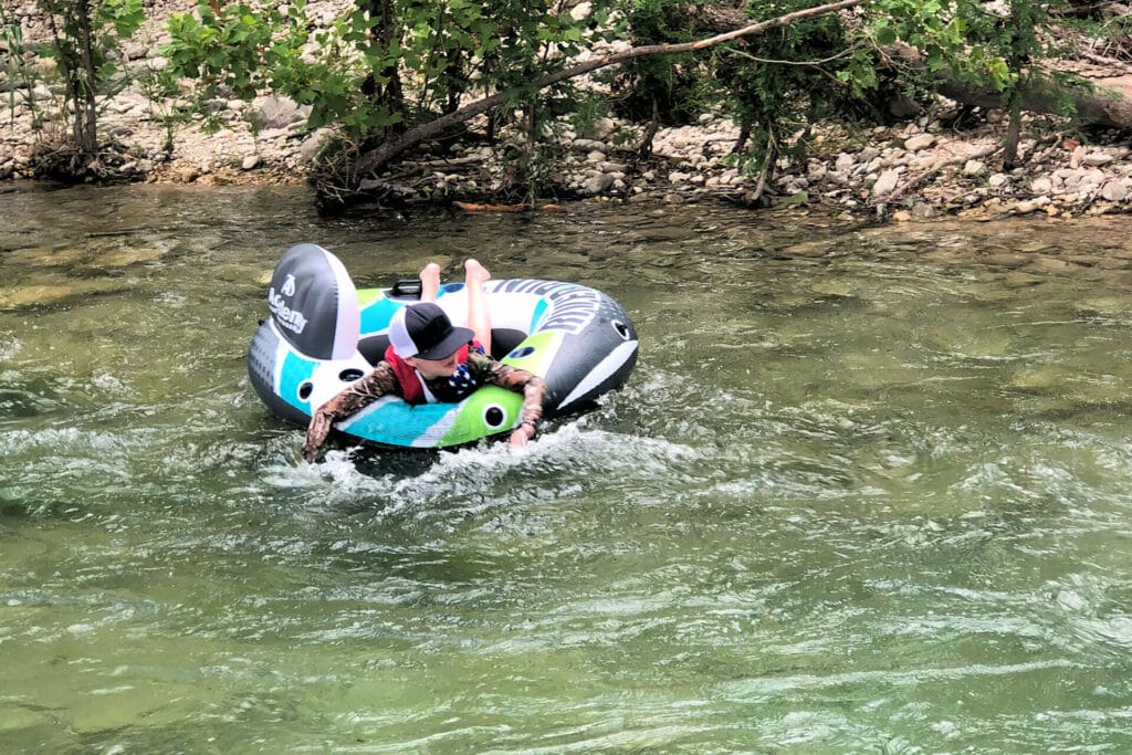 Boy floating down the Frio River