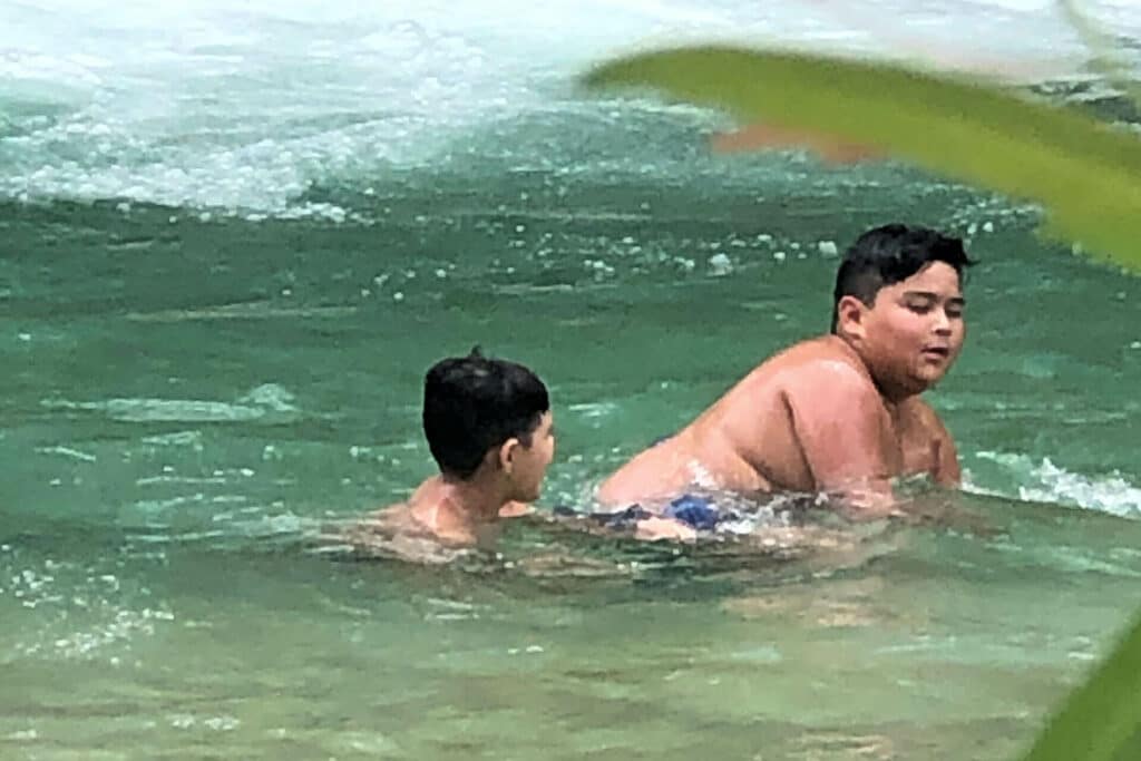 Two kids playing in the shallows of the Frio River