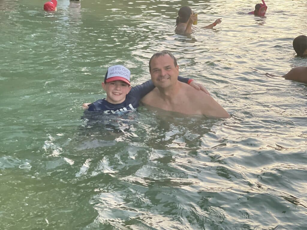 Dad with son in water